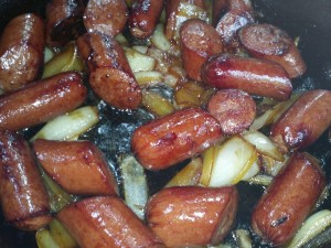 cooked 2 Castiron pan of camelized onlions and cooked Kielbasa